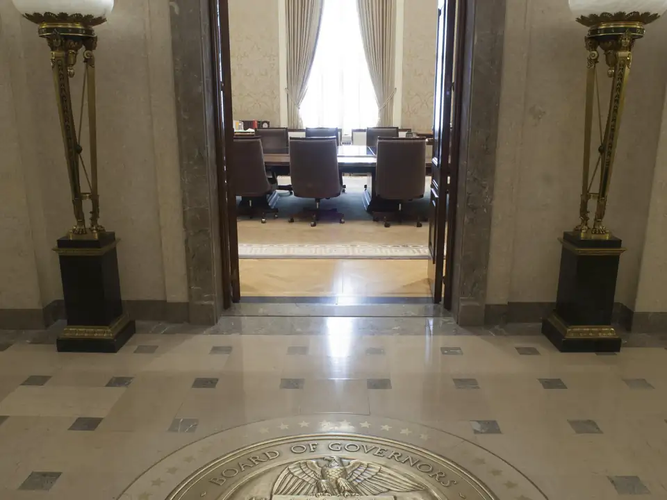 The entrance to the Federal Open Market Committee board room, with a long table and chairs
